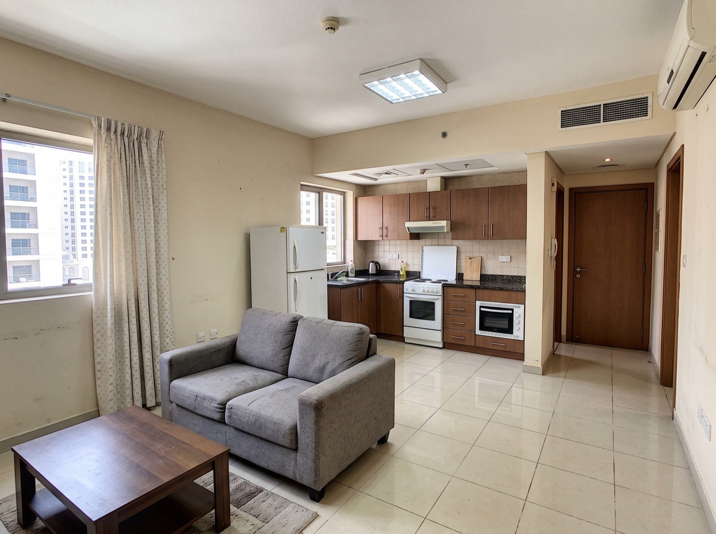 Apartment before renovation — builder-grade kitchen and tiles